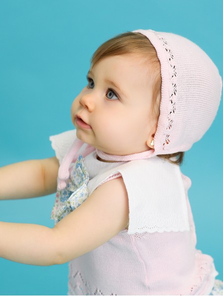 Knit baby bonnet with openwork details